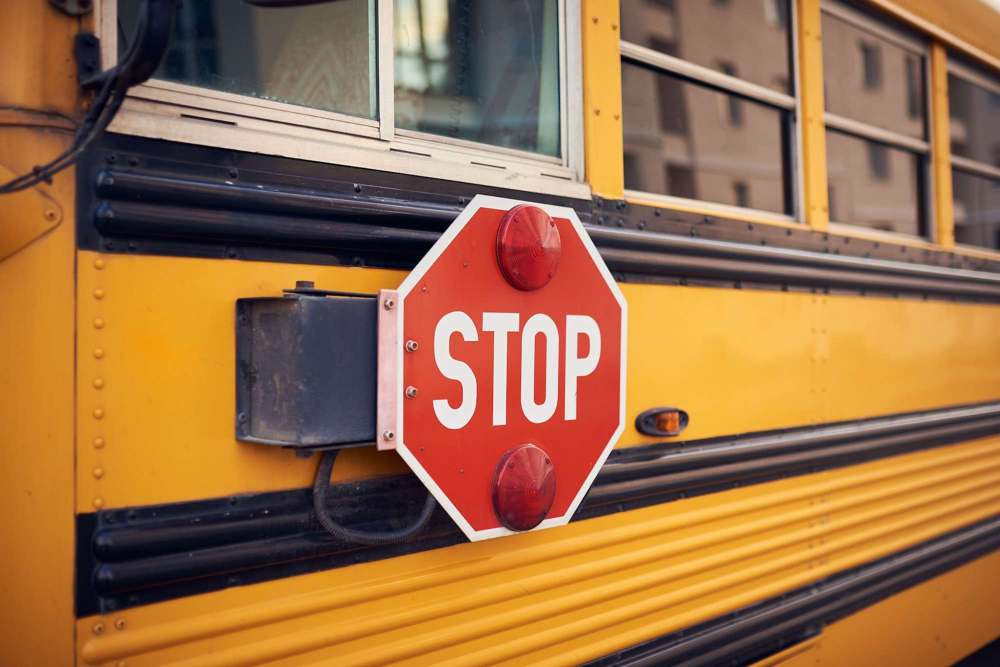 Side view of a school bus and its stop signal